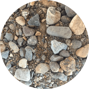 An up close view of very fine sand mixed with small pebbles.